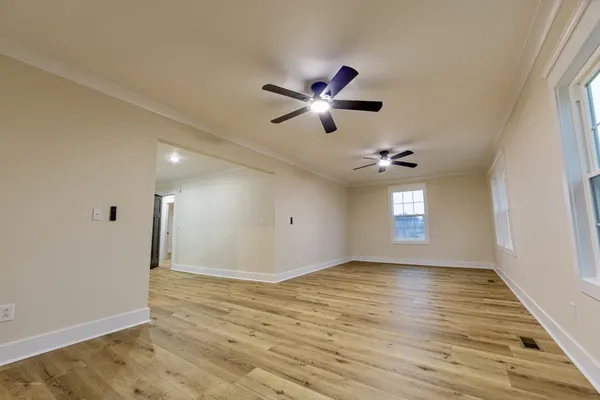 wooden floor in an empty room with a window