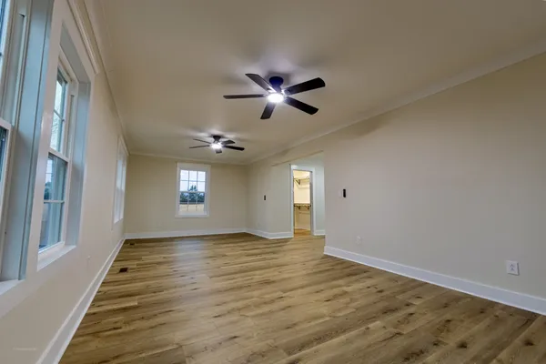 wooden floor in an empty room with a window
