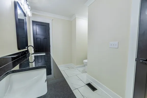 a bathroom with a sink and mirror