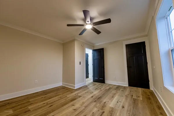 a view of empty room with wooden floor
