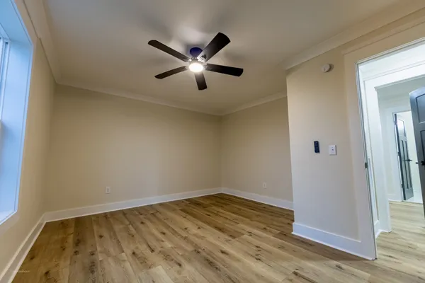 a view of empty room with wooden floor