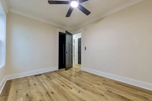 a view of empty room with wooden floor