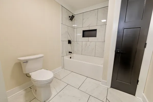 a bathroom with a toilet and a shower