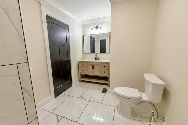 a bathroom with a sink a toilet and mirror