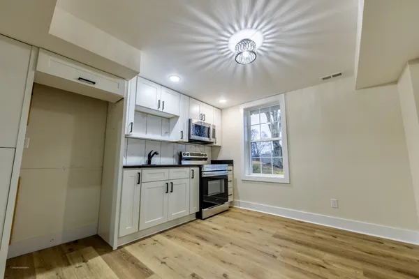a kitchen with stainless steel appliances a stove a sink and a refrigerator