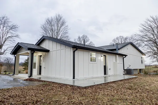 a view of a house with a wooden fence