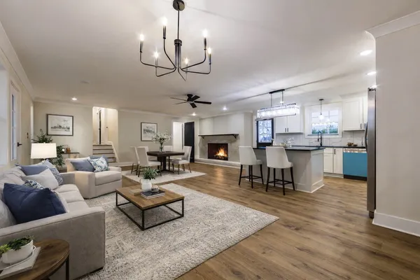 a living room with fireplace furniture and a wooden floor