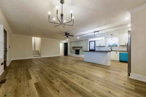 a view of a kitchen with cabinets and wooden floor
