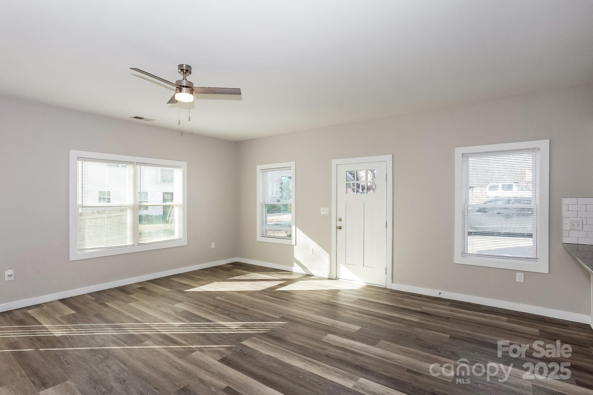 335 Todd Road Charlotte, NC 28208 - Photo 3 of 15 a view of empty room with wooden floor and fan