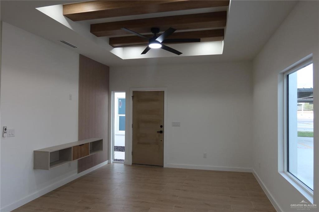 2905 Estevan Street, Unit 2 Mission, TX 78574 - Photo 3 of 11 an empty room with wooden floor cabinet and windows