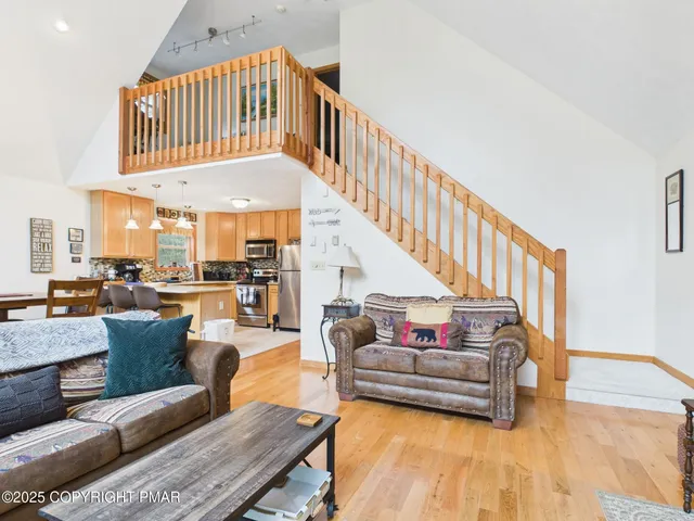 a living room with furniture and large windows