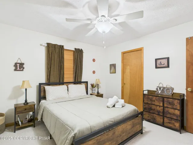 a bedroom with a bed dresser and a window