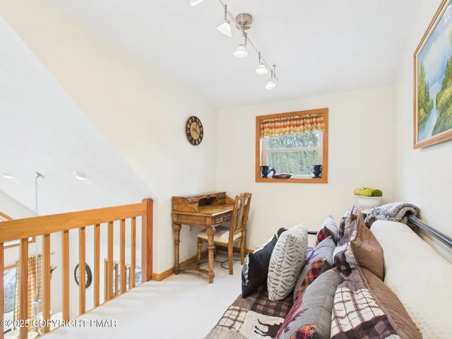 a living room with furniture and large windows