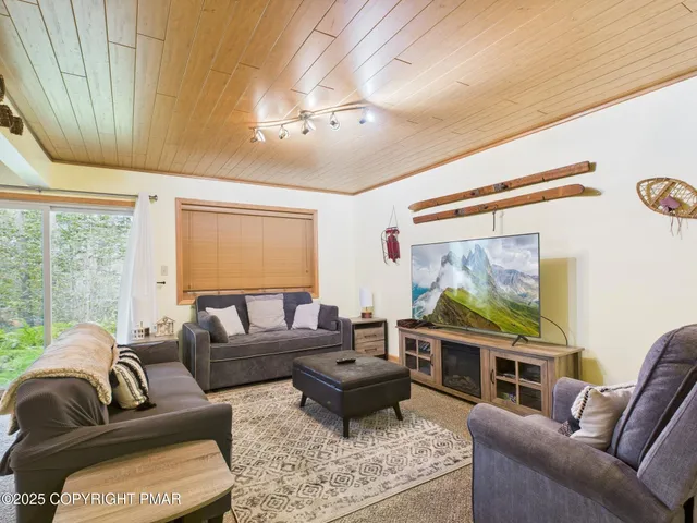 a view of roof deck with wooden floor and fence