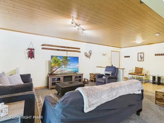 a view of roof deck with chair and wooden floor