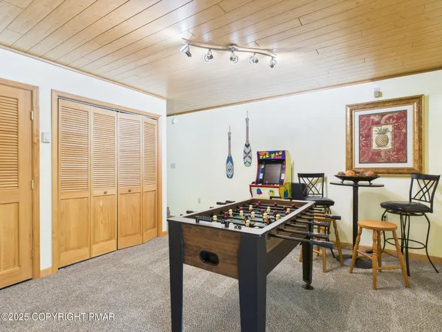 a view of a dining room with furniture and a chandelier