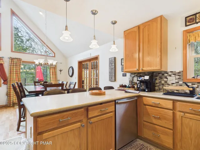 a living room with furniture a large window and a fireplace