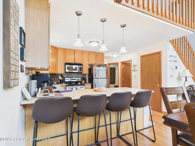 a living room with furniture or stairs and a wooden floor