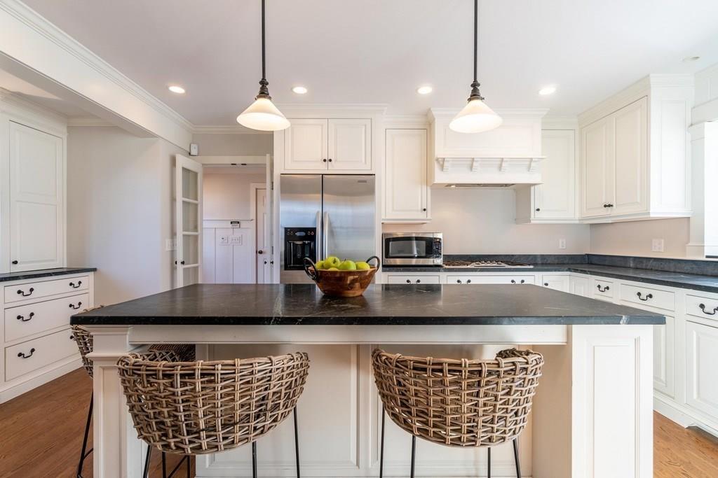 43 Burditt Avenue Hingham, MA 02043 - Photo 14 of 41 a kitchen with a kitchen island white cabinets and stainless steel appliances