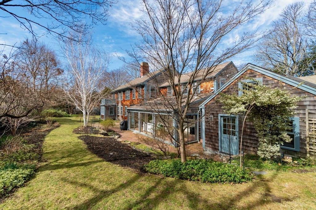 43 Burditt Avenue Hingham, MA 02043 - Photo 5 of 41 a view of a white house next to a yard with a large tree