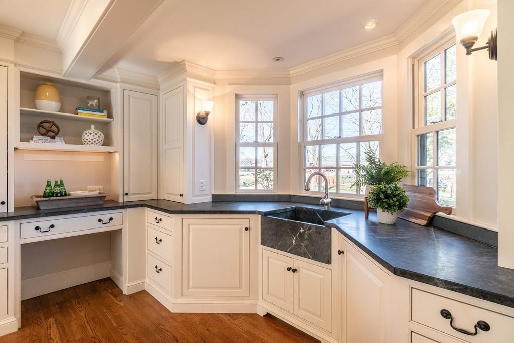 43 Burditt Avenue Hingham, MA 02043 - Photo 10 of 41 a kitchen with granite countertop white cabinets white appliances a sink and a large window
