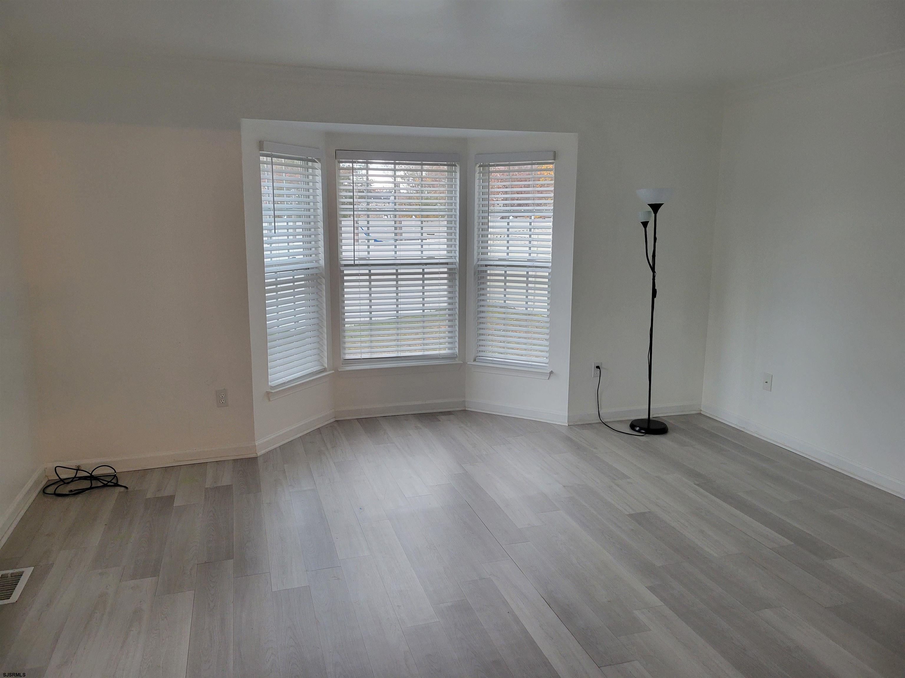 21 Sugarberry Road Egg Harbor Township, NJ 08234 - Photo 11 of 59 an empty room with wooden floor and windows