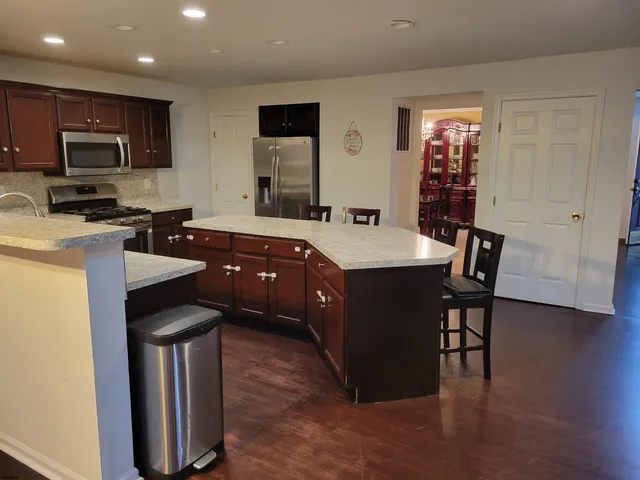a view of a dining room with furniture and chandelier