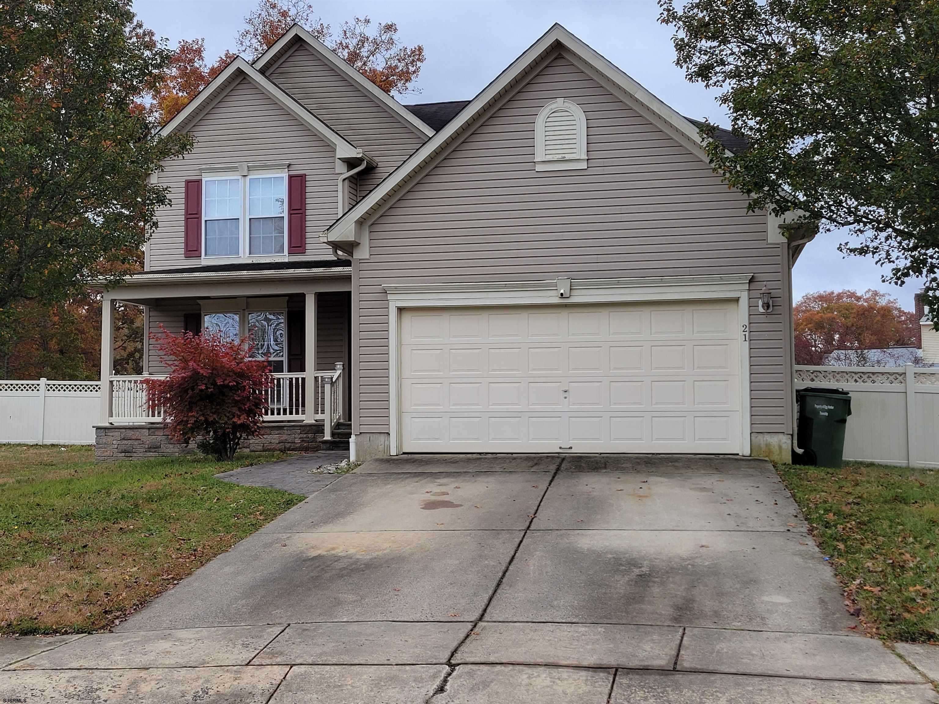 21 Sugarberry Road Egg Harbor Township, NJ 08234 - Photo 2 of 59 a front view of a house with a yard and garage