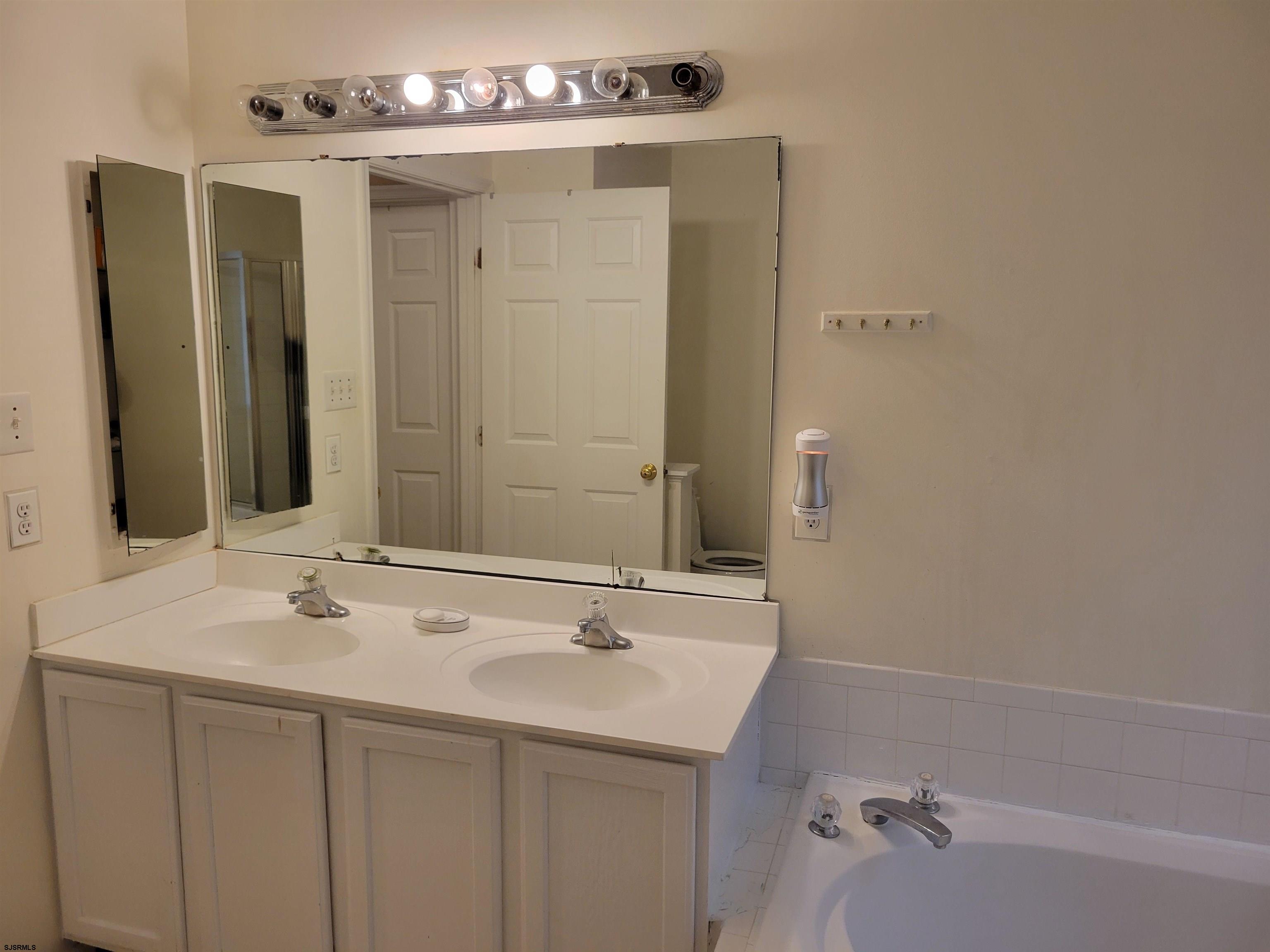 21 Sugarberry Road Egg Harbor Township, NJ 08234 - Photo 30 of 59 a bathroom with a sink and a mirror