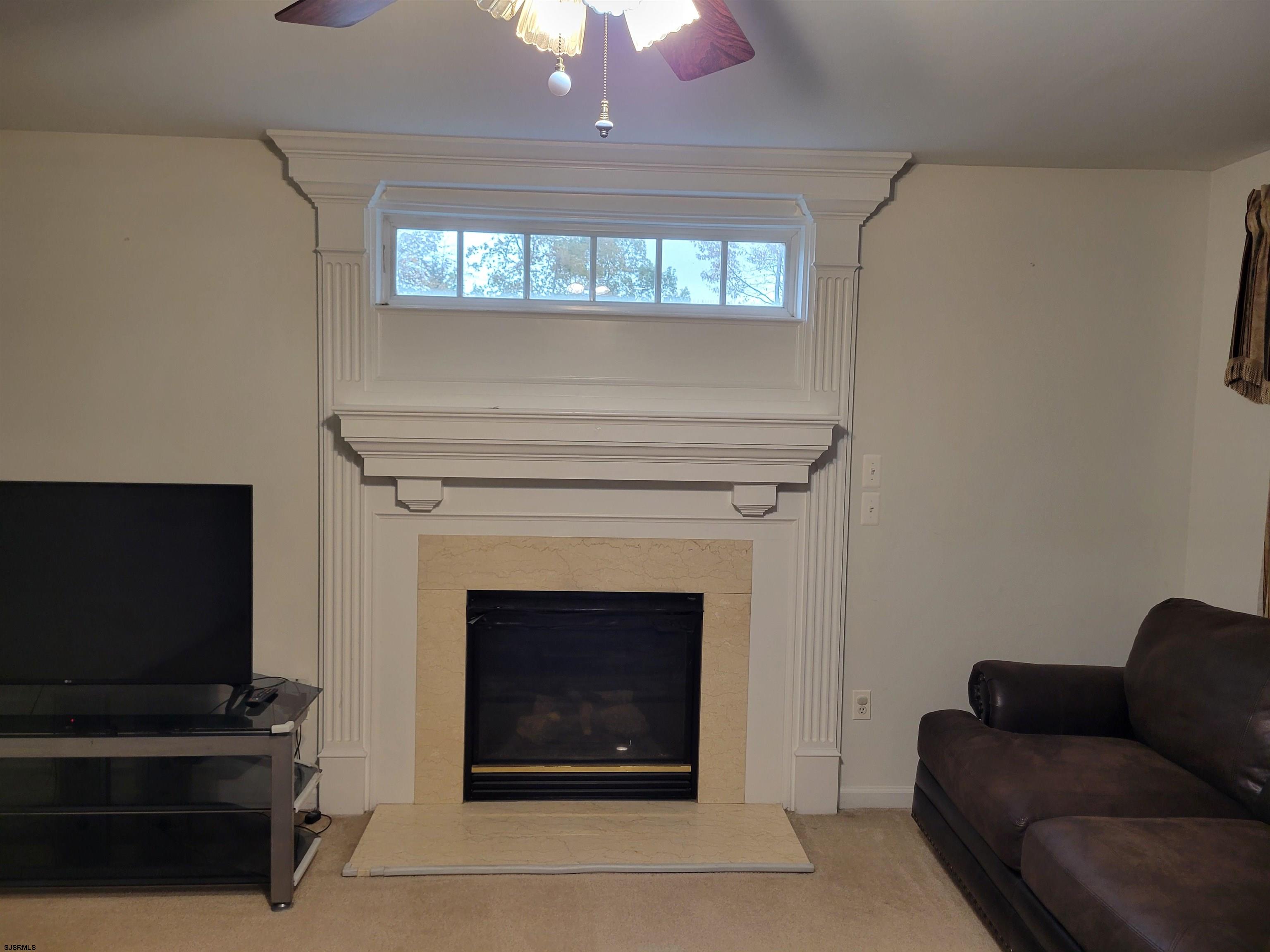 21 Sugarberry Road Egg Harbor Township, NJ 08234 - Photo 33 of 59 a living room with furniture a flat screen tv and a fireplace