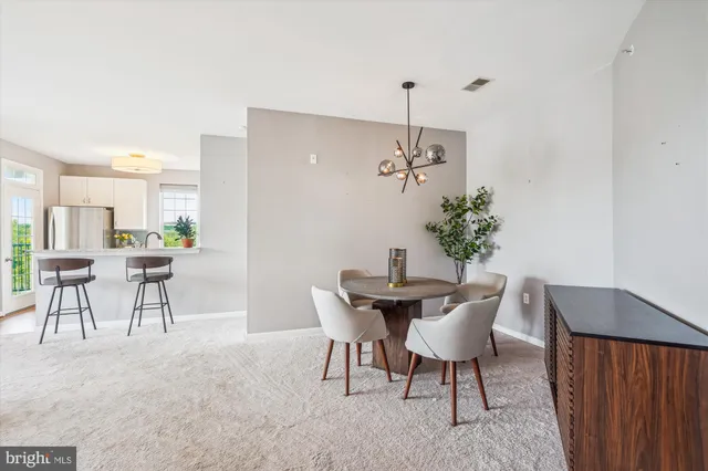 a view of a dining room with furniture and chandelier