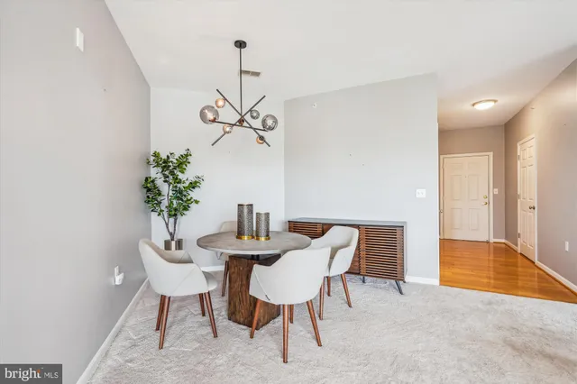 a view of a room with a table and chairs