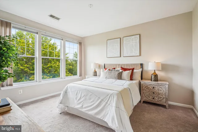 a bedroom with a bed and a large window