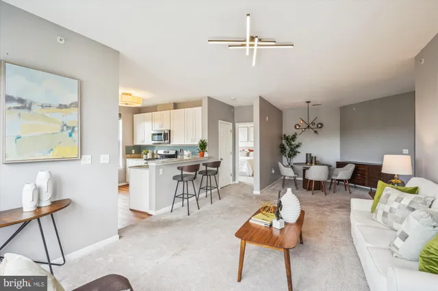 a living room with furniture and kitchen view