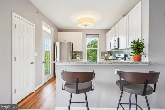 a very nice looking dining room with a window and kitchen view