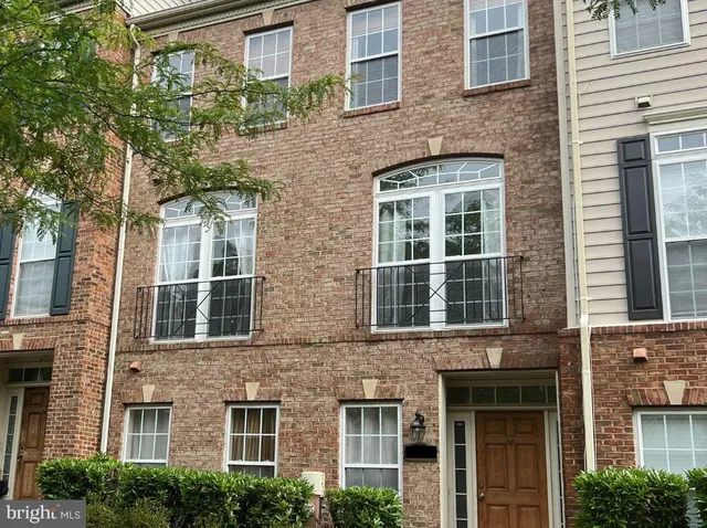 a view of a brick building next to a yard