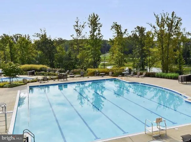 a view of swimming pool with a yard and seating area
