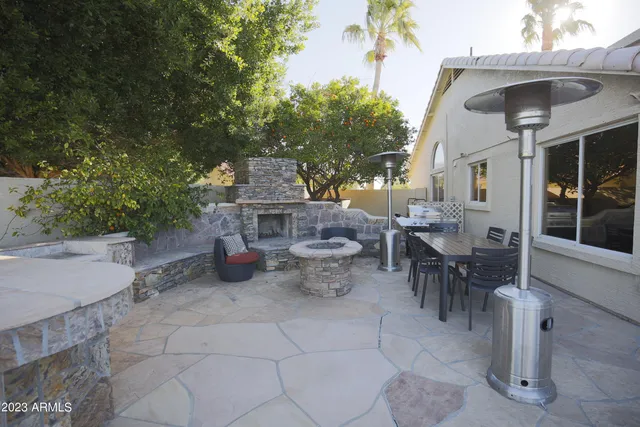 a view of a patio with table and chairs potted plants