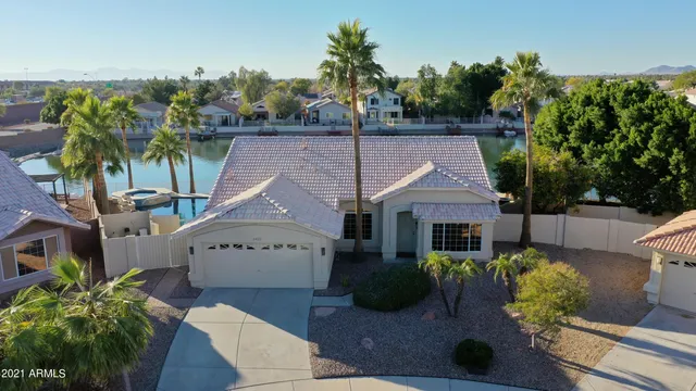 an aerial view of residential houses with outdoor space and lake view