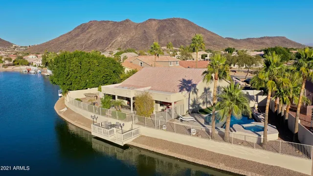 an aerial view of residential houses with outdoor space and river