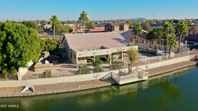 an aerial view of a house with a mountain