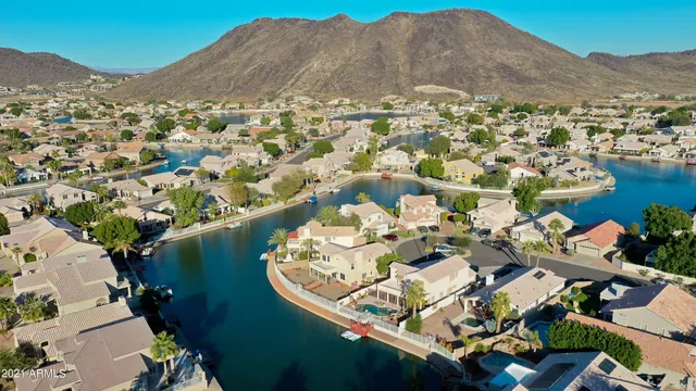 a view of a lake with couches and wooden floor