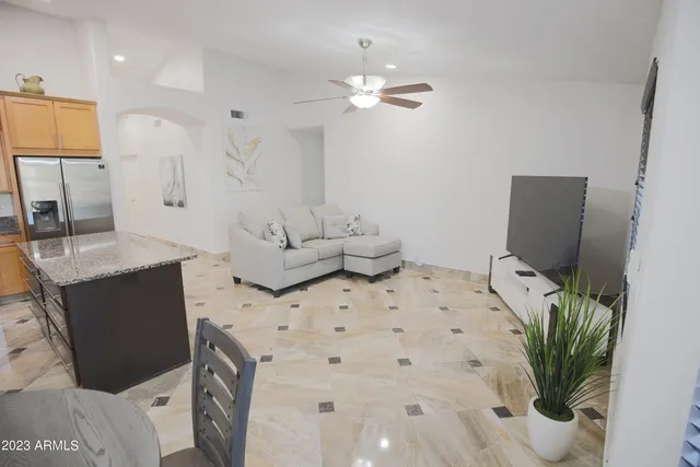 a kitchen with granite countertop a sink stainless steel appliances and cabinets