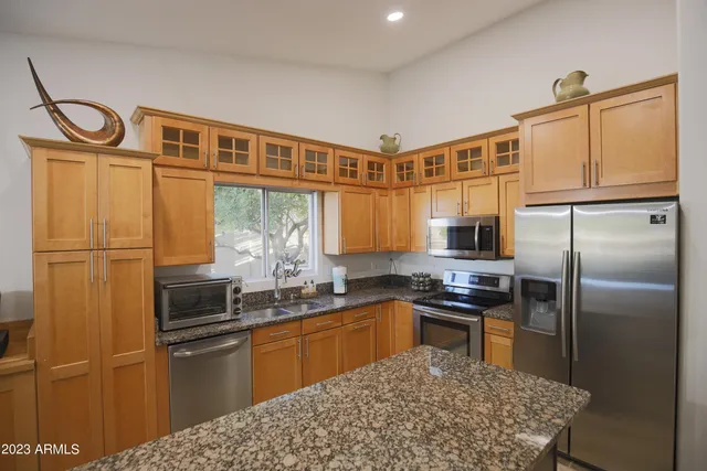 a kitchen with a stove a sink and a microwave