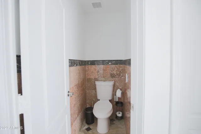 a en suite bathroom with a granite countertop sink and a mirror