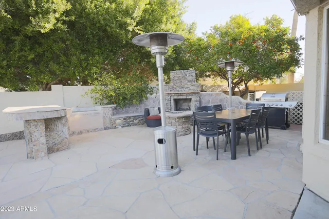 a view of a patio with table and chairs
