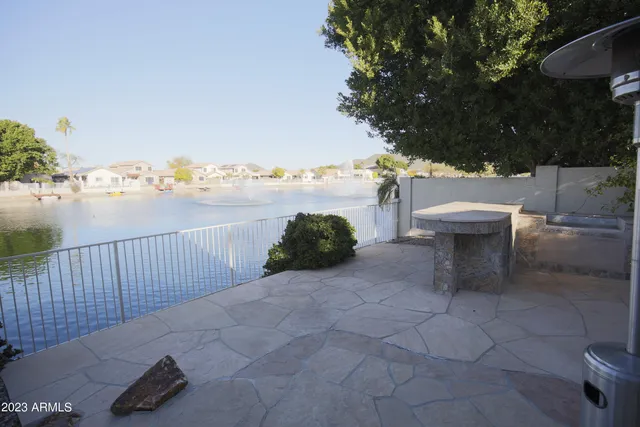 a view of a terrace with lawn chairs