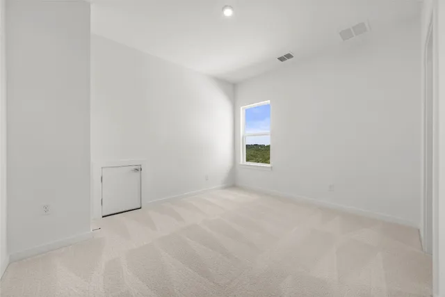 a view of an empty room and a window