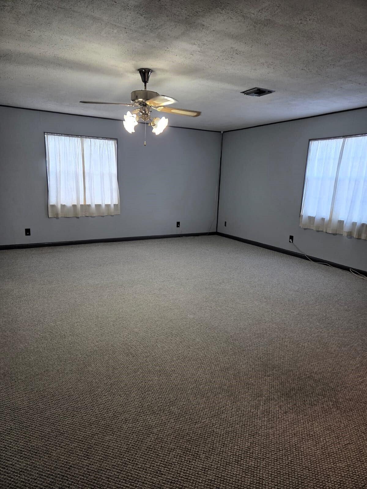 1060 West 26th Court Riviera Beach, FL 33404 - Photo 11 of 23 a view of a livingroom with a ceiling fan and window