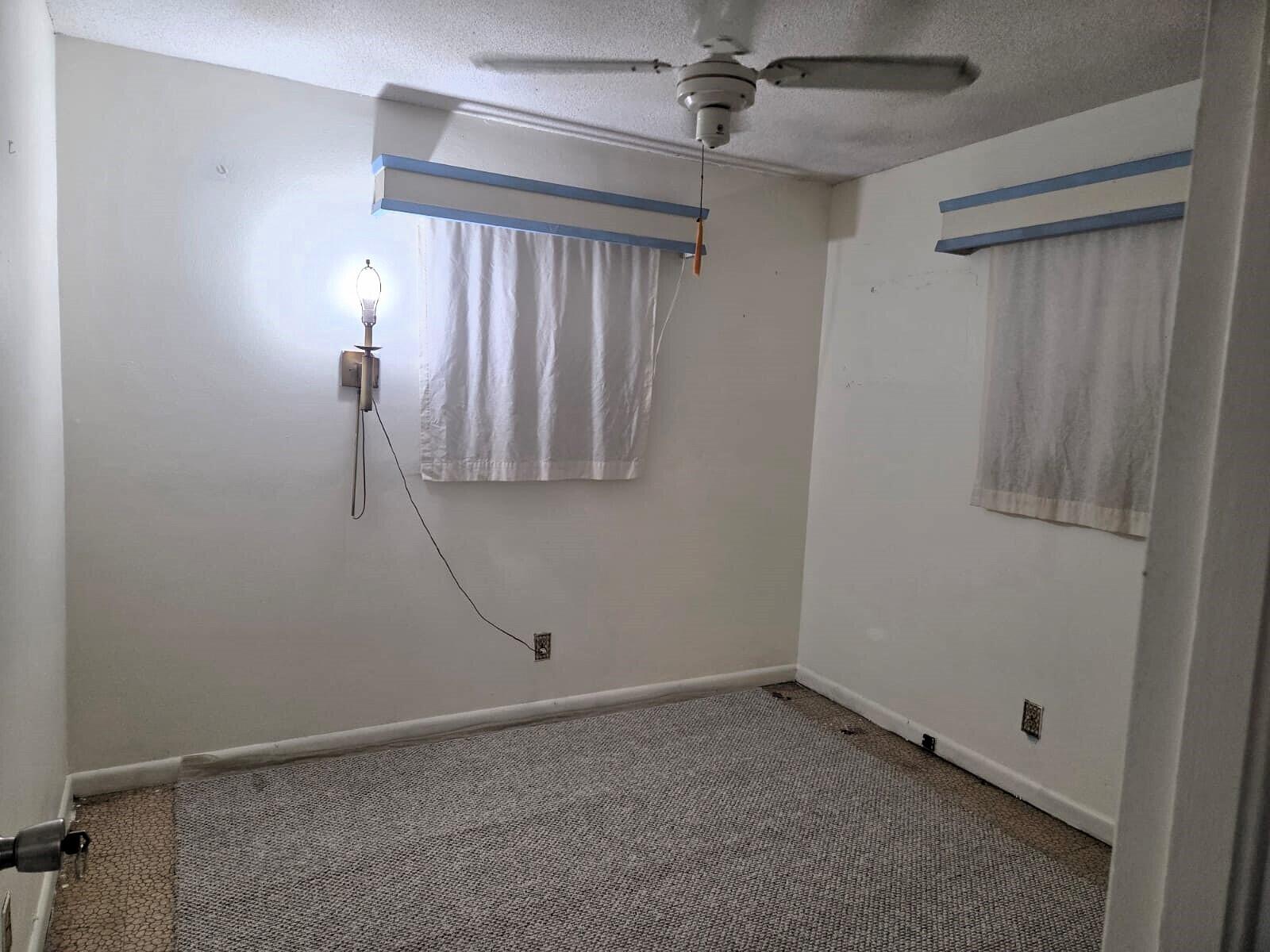 1060 West 26th Court Riviera Beach, FL 33404 - Photo 13 of 23 an empty room with a ceiling fan